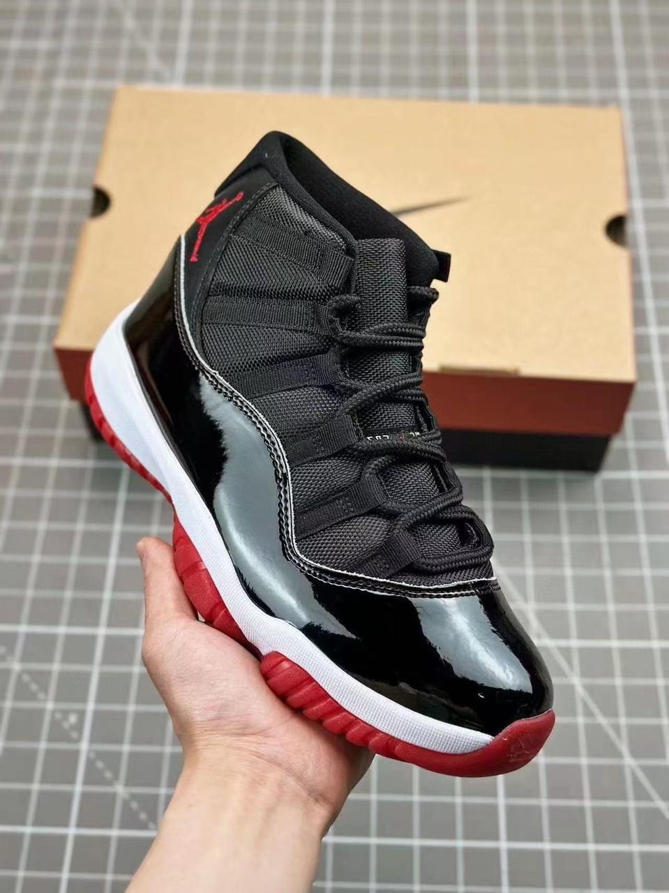 Iconic Air Jordan 11 sneakers featuring glossy patent leather, breathable mesh upper, responsive cushioning, and durable rubber outsole. Timeless design delivering premium comfort, style,