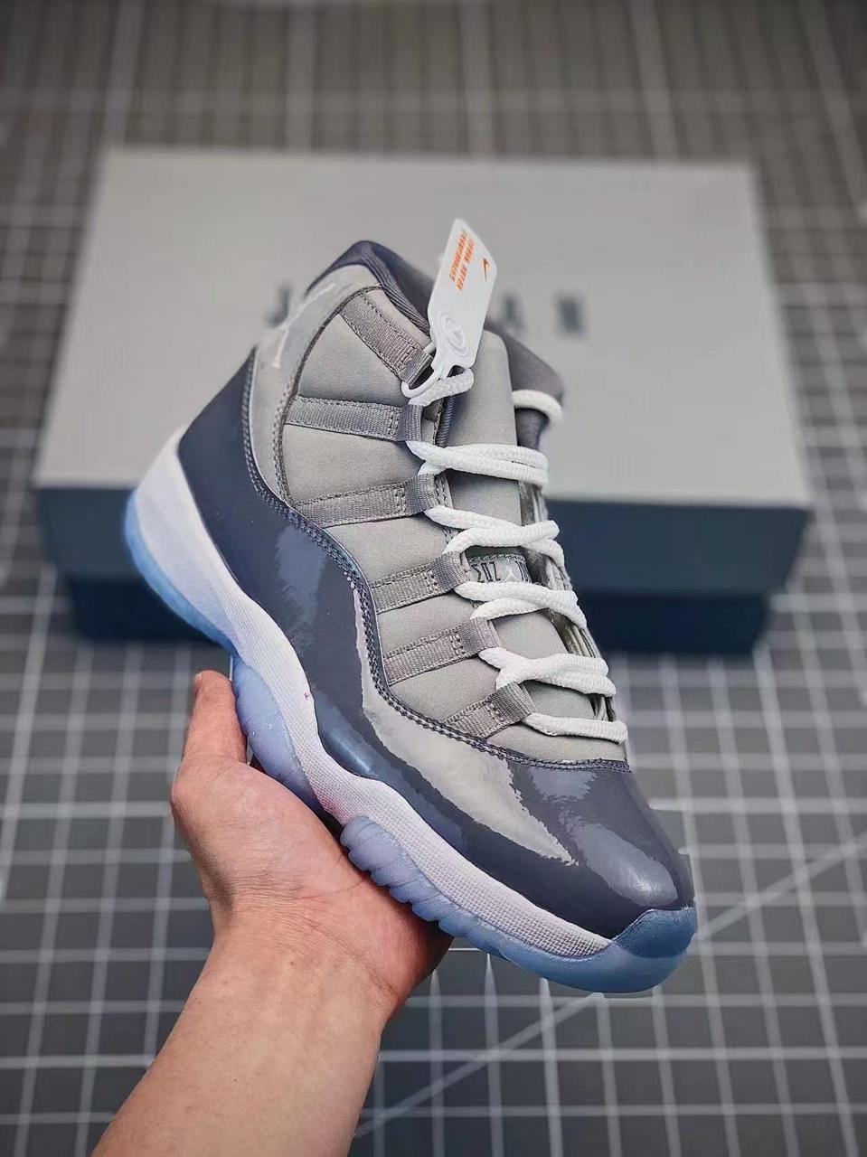 Iconic Air Jordan 11 sneakers featuring glossy patent leather, breathable mesh upper, responsive cushioning, and durable rubber outsole. Timeless design delivering premium comfort, style,