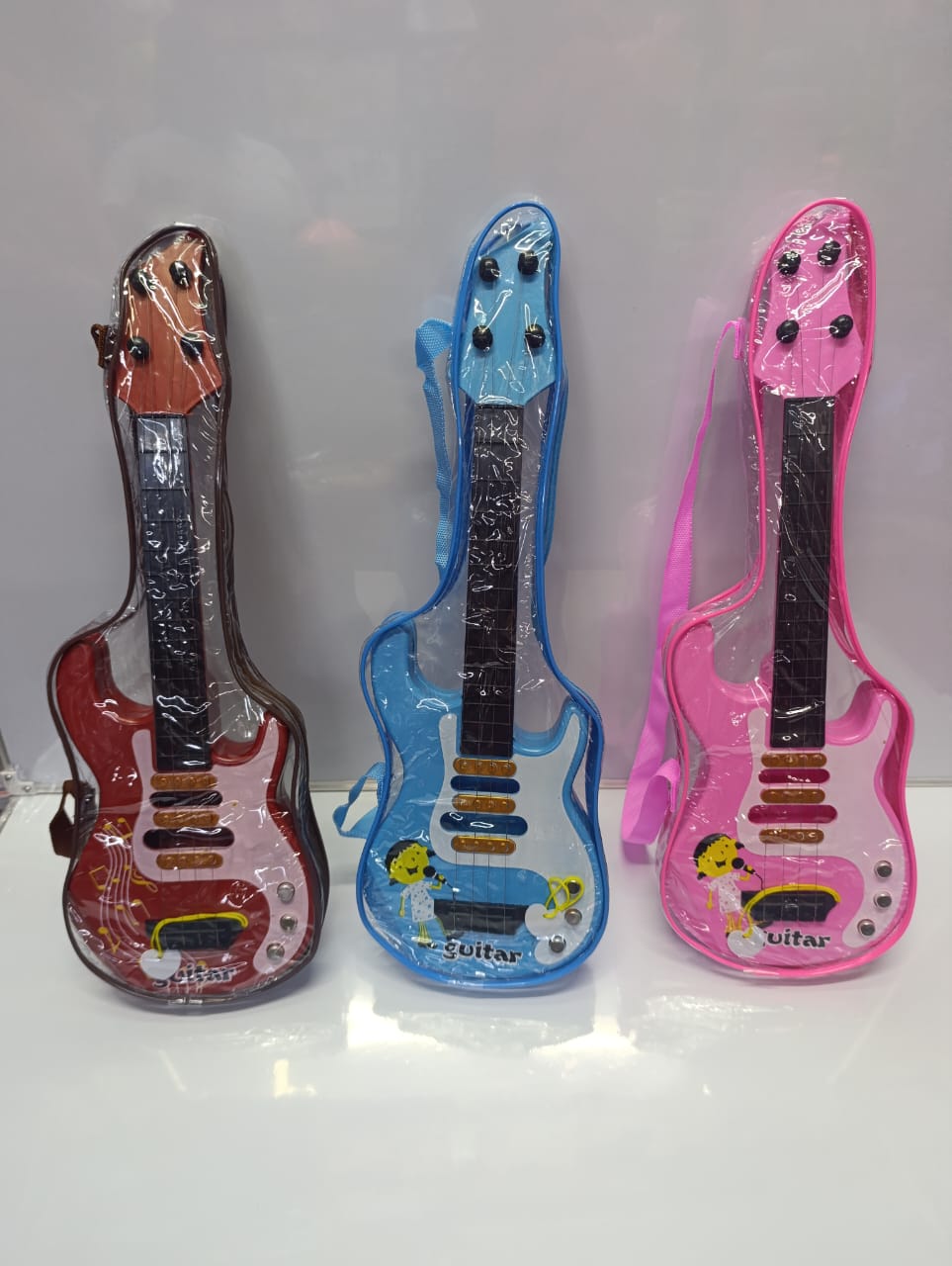 Mini Melodies KIDS Guitar!  4 Strings of Fun – Perfect for Little Rockstars!  Musical toy guitar designed to spark creativity and rhythm in young minds.  Available in cute colours