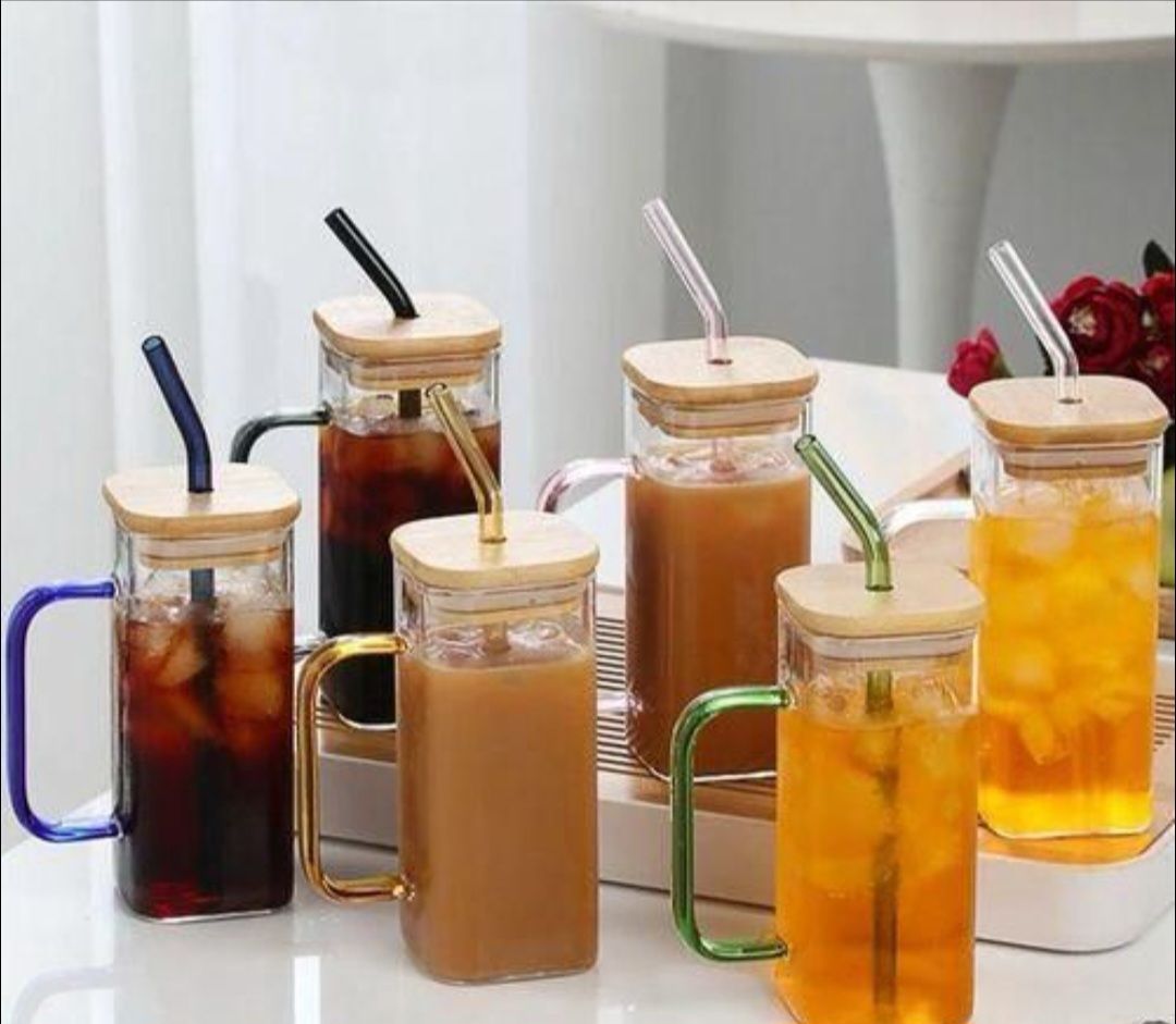 Glass mug features a bamboo lid and a straw, ideal for both hot and cold drinks.