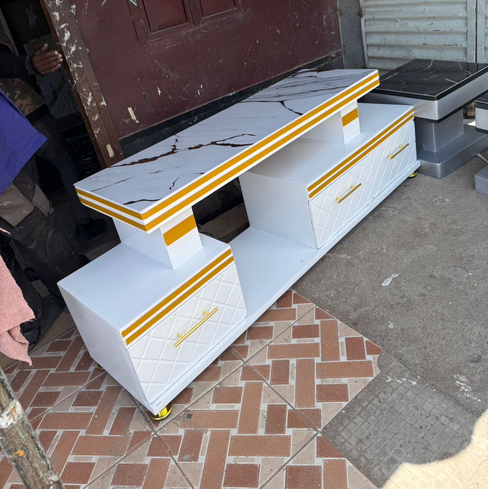 Executive tv stand with marble coating and lightCrafted from engineered wood and finished with a marble laminate surface, the stand offers durability and a premium look. The built-in lighting adds amb