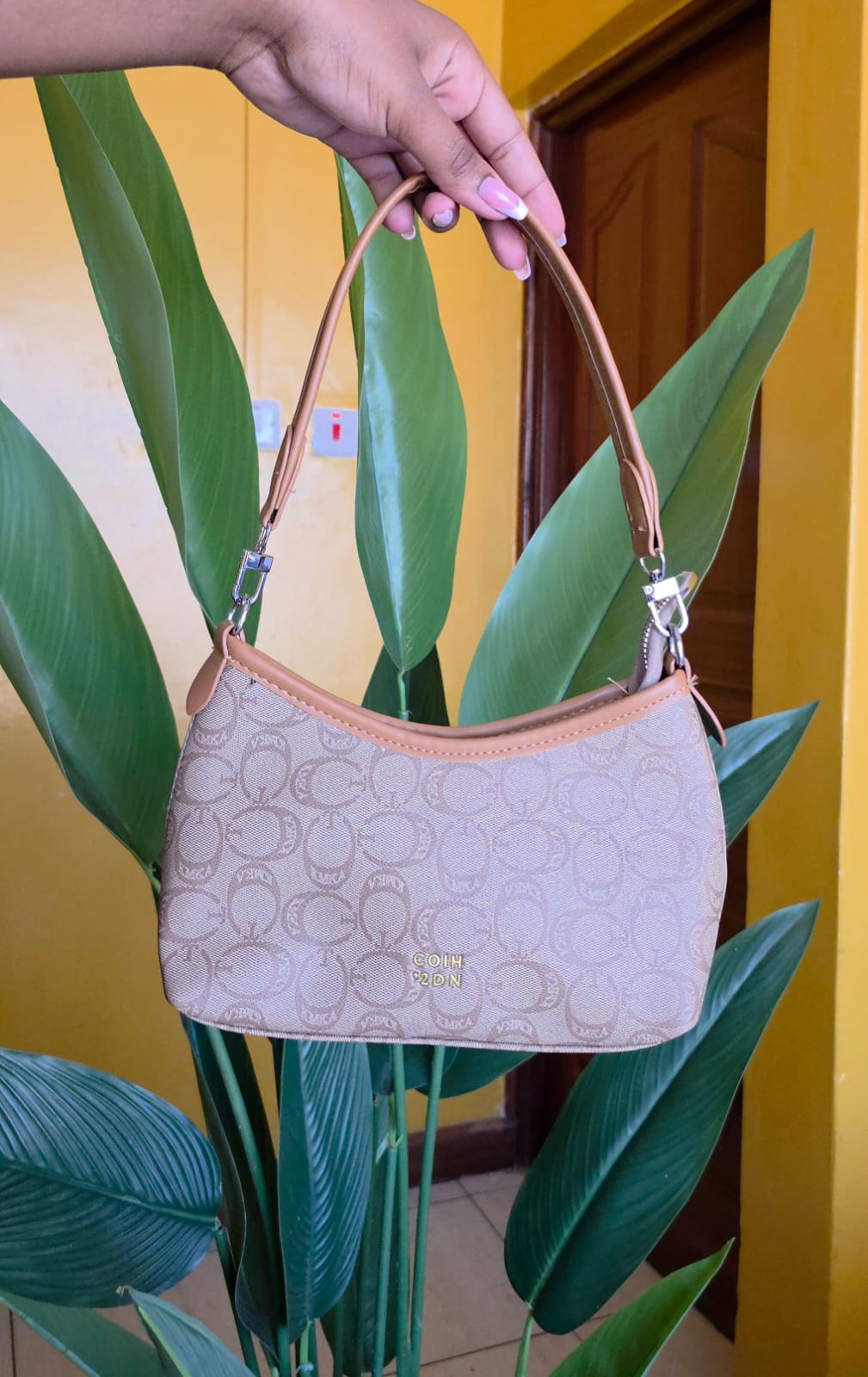 Stylish Ladies shoulder bag that is modern,sophisticated and affordable.It features a classic monogram print on durable coated canvas, complemented by smooth tan leather trim and a sturdy top handle.