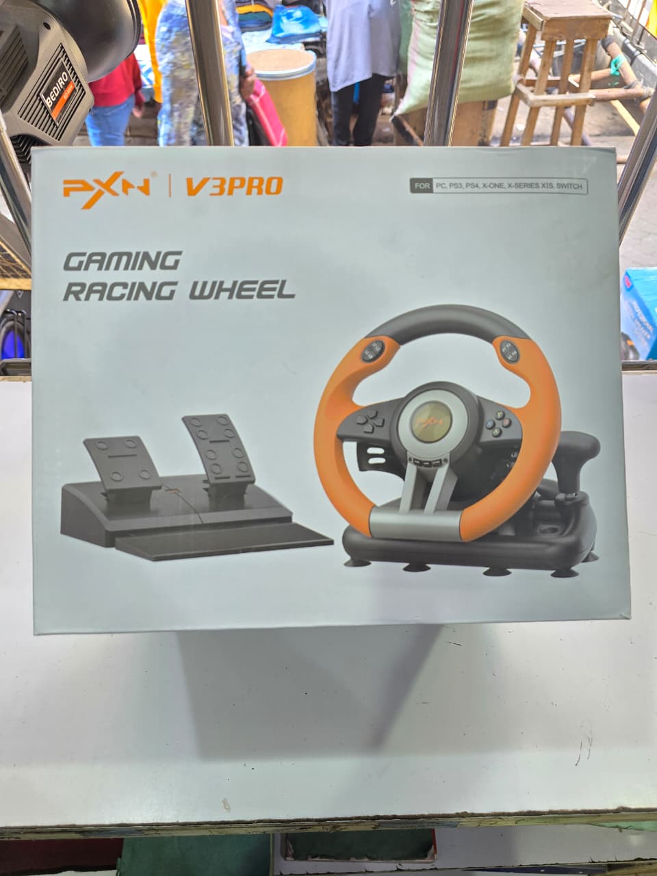 PXN V3 PRO Gaming Racing Wheel. 
It is a gaming accessory designed to provide a realistic racing experience for various gaming platforms. 
Components: It typically includes a steering wheel and a set