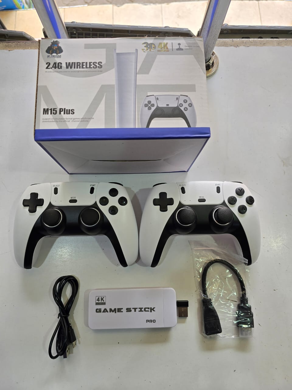 M15 Plus Game Stick Pro, which is a type of retro video game console designed for plug-and-play use with a TV or monitor. 
This gaming system typically includes:
M15 Plus Console/Game Stick: A compact