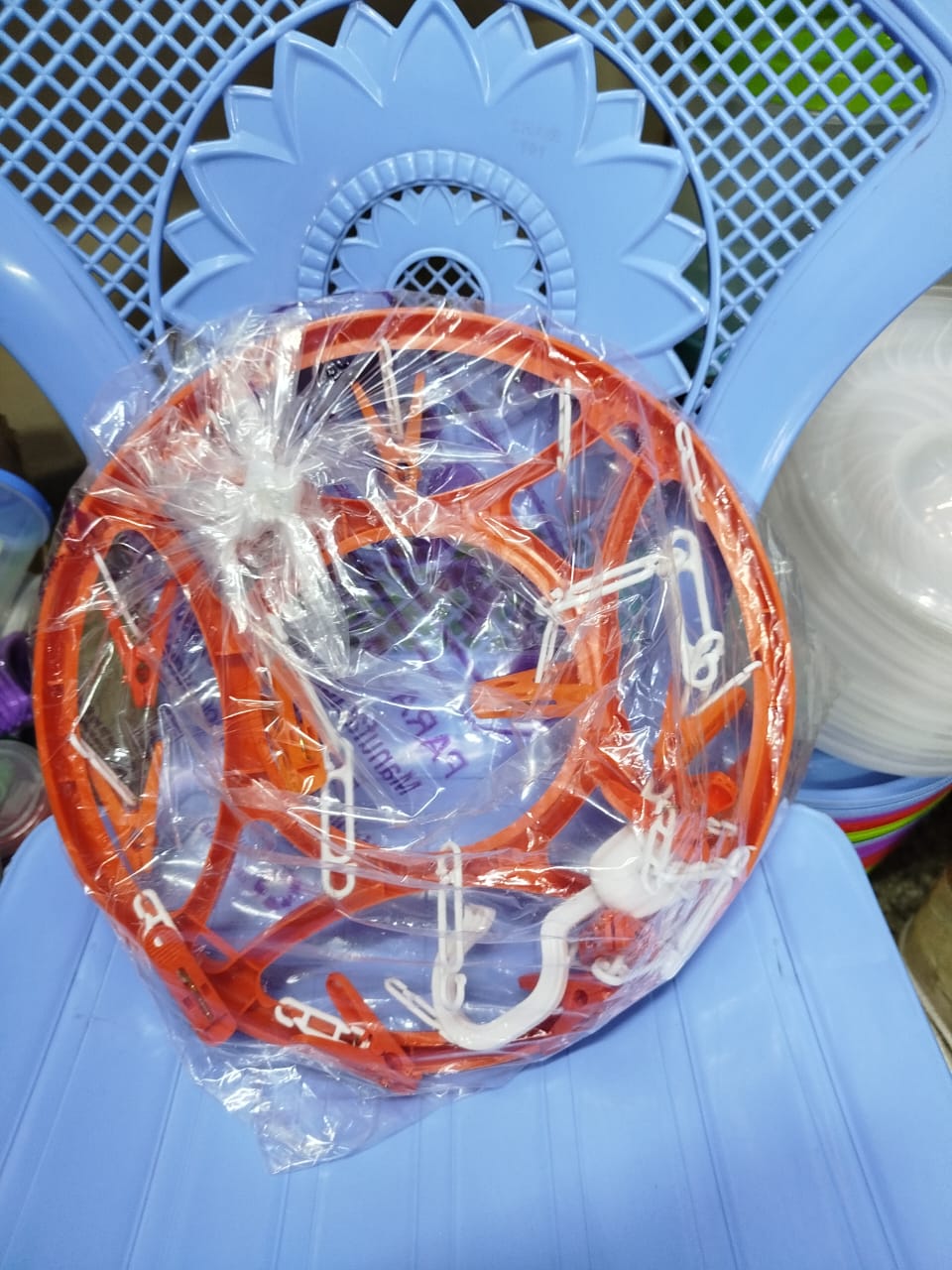 circular clothes drying rack with clips, often used for hanging and air-drying small items of clothing like socks, underwear, or baby clothes. 
Explanation: 
Design: It features a circular frame with