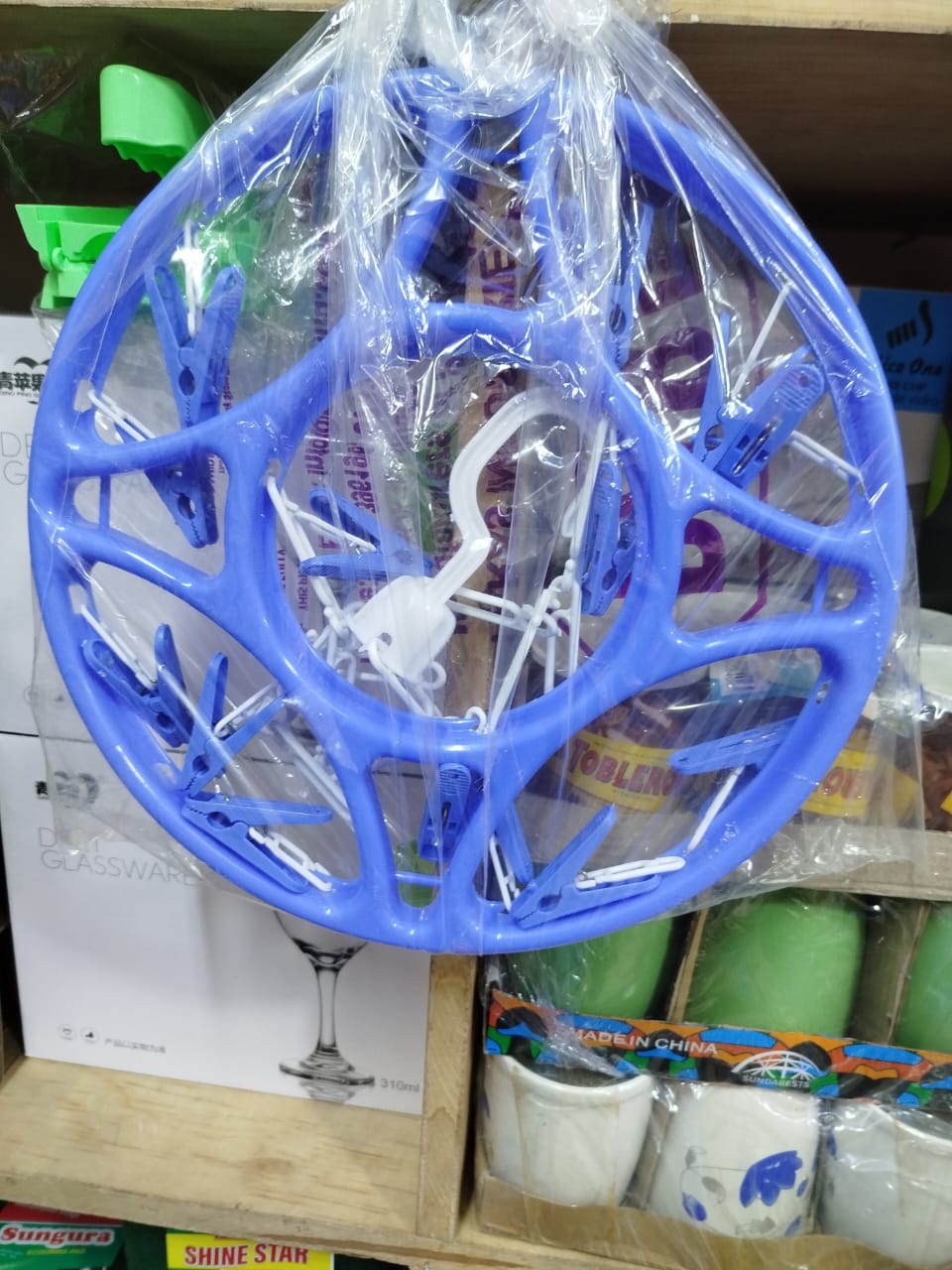 circular clothes drying rack with clips, often used for hanging and air-drying small items of clothing like socks, underwear, or baby clothes. 
Explanation: 
Design: It features a circular frame with