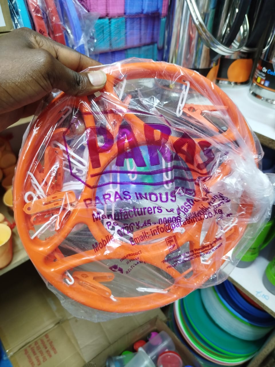 circular clothes drying rack with clips, often used for hanging and air-drying small items of clothing like socks, underwear, or baby clothes. 
Explanation: 
Design: It features a circular frame with