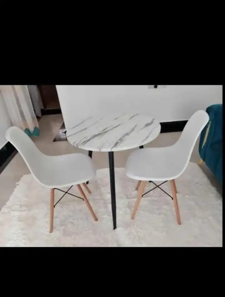 Two seater minimalist modern dining. Two strong chairs enhanced with metal rods One table size 60×60×70cm Metal stands