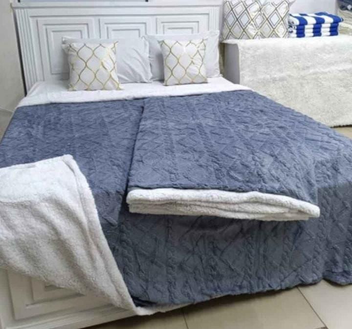 Cozy fleece woolen blanket. Crafted with high-quality, thickened fabric, this blanket provides exceptional insulation and plush comfort. Stay warm and cozy during chilly nights or relaxing moments.