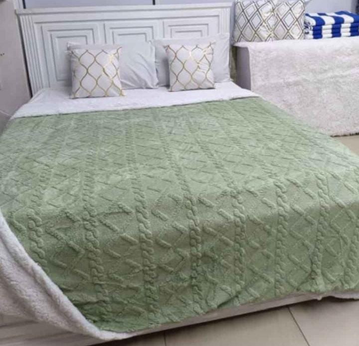 Cozy fleece woolen blanket. Crafted with high-quality, thickened fabric, this blanket provides exceptional insulation and plush comfort. Stay warm and cozy during chilly nights or relaxing moments.