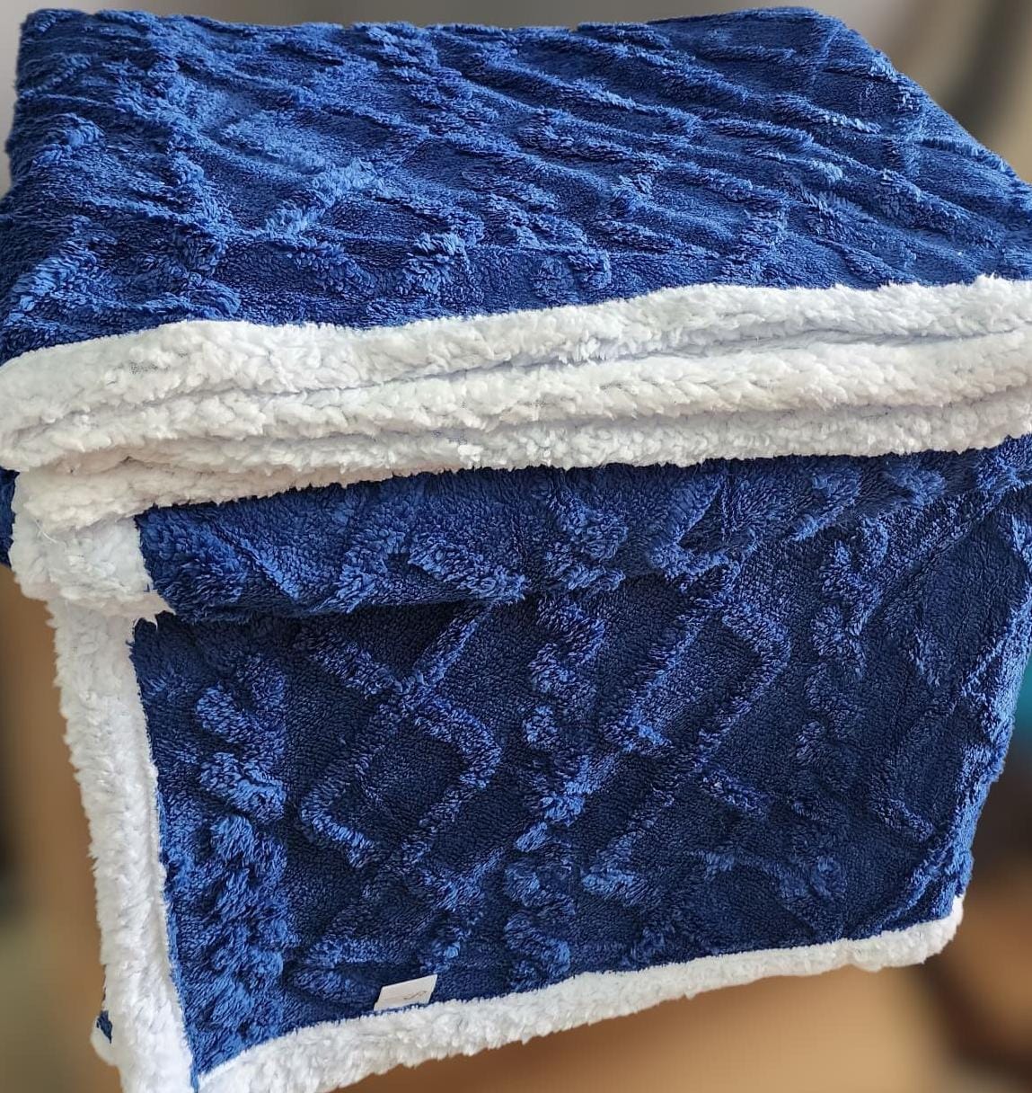 Cozy fleece woolen blanket. Crafted with high-quality, thickened fabric, this blanket provides exceptional insulation and plush comfort. Stay warm and cozy during chilly nights or relaxing moments.
