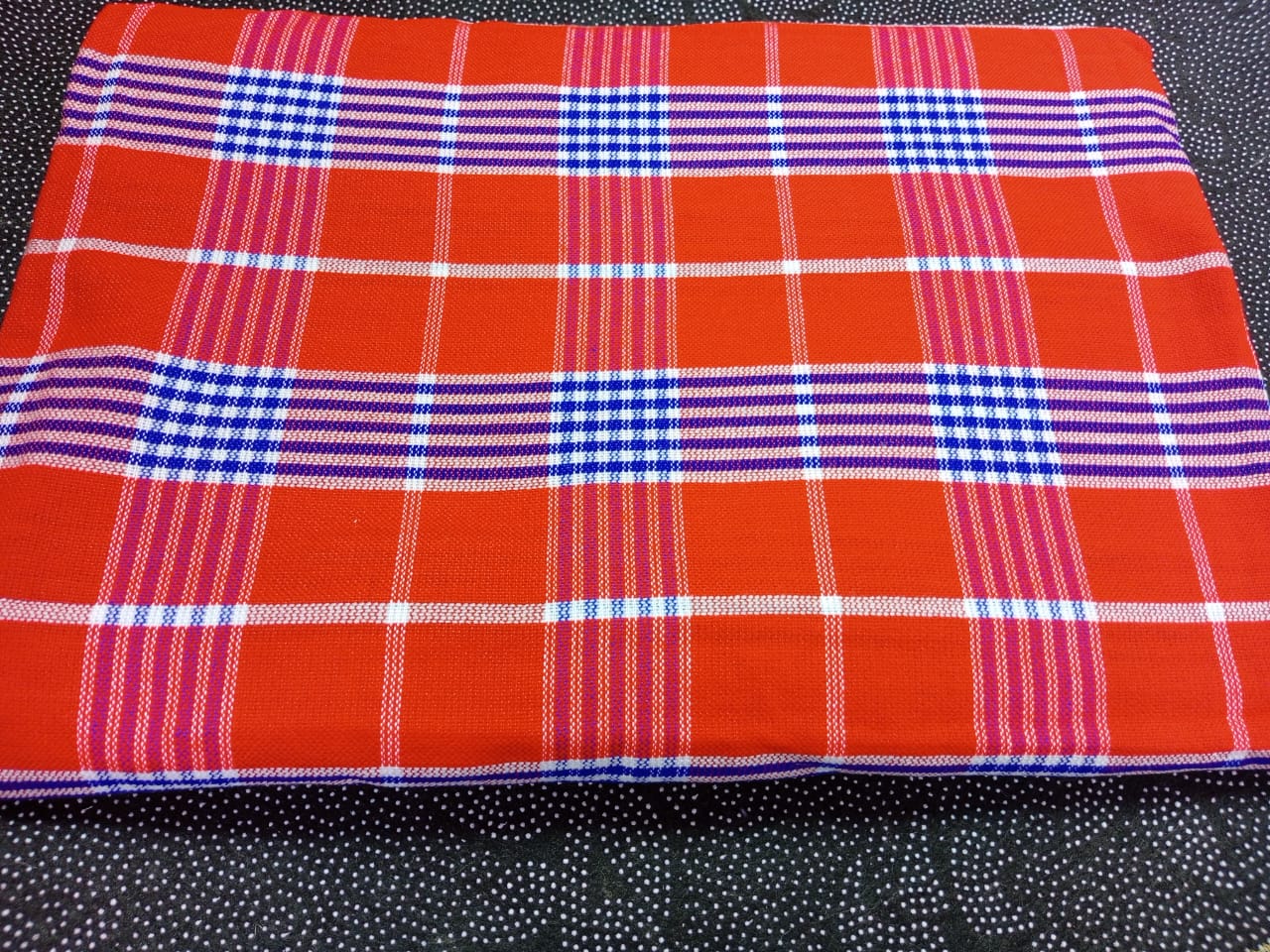 Masai Shuka.Crafted from high-quality cotton or acrylic blends, this blanket is designed to be both warm and breathable, making it ideal for outdoor adventures.