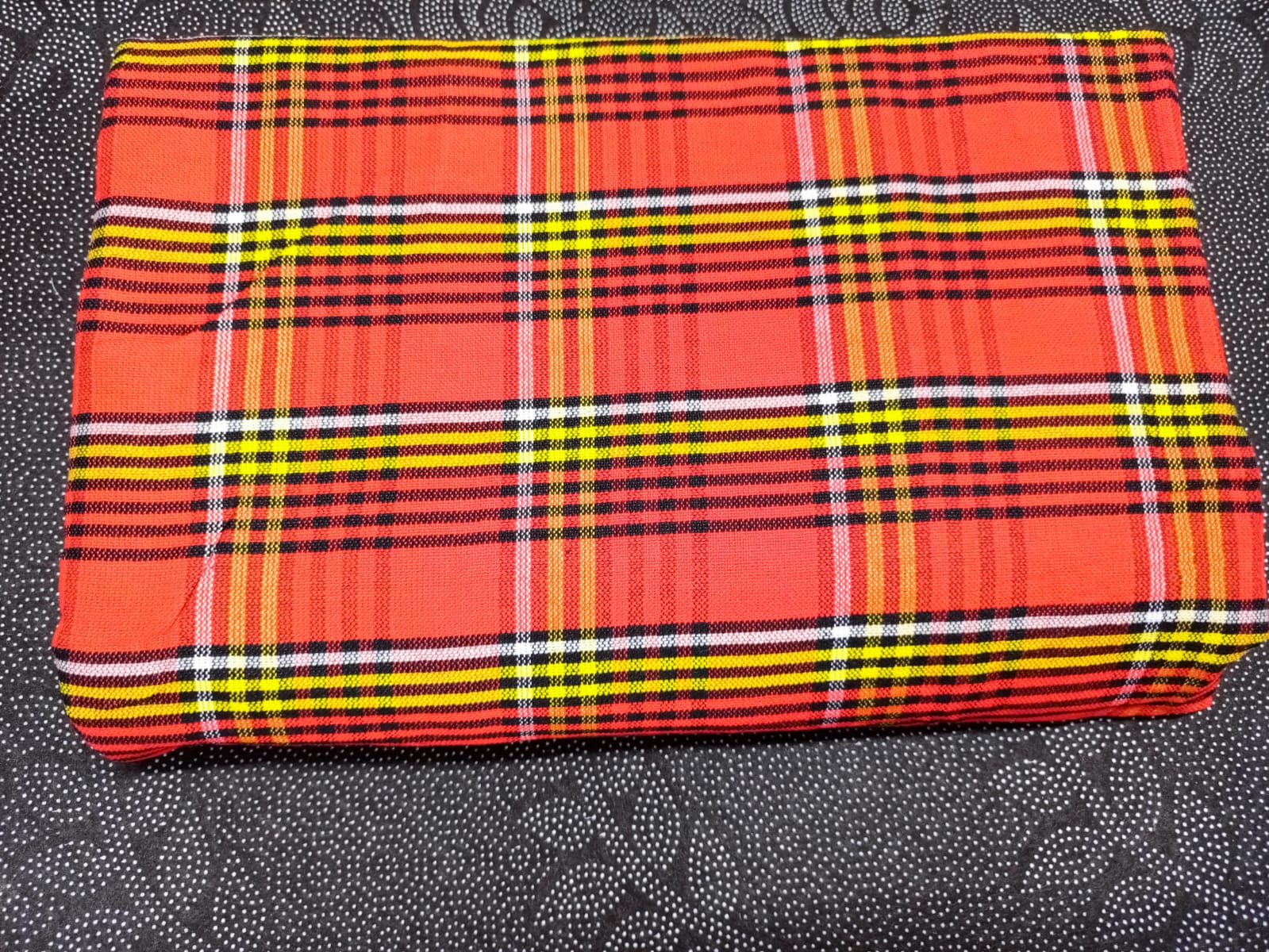 Masai Shuka.Crafted from high-quality cotton or acrylic blends, this blanket is designed to be both warm and breathable, making it ideal for outdoor adventures.