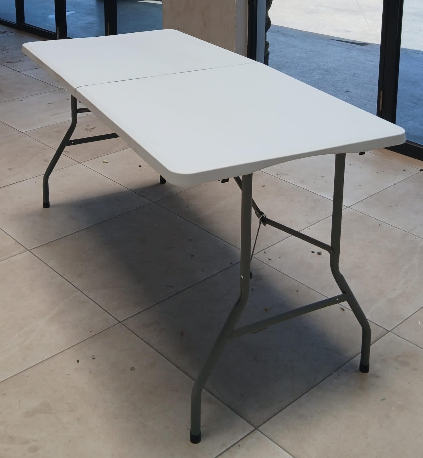 FOLDING TABLE. Portable Folding Table, Features foldable legs that tuck underneath the tabletop for compact storage and easy transport.