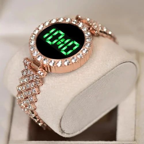 Ladies LED Watch paired with coordinating stackable bracelets.a watch comes as  set with multiple stackable bracelets, often including heart shaped charms or leaf motifs gold-tone watch with a crystal