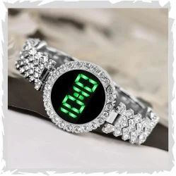 Ladies LED Watch paired with coordinating stackable bracelets.a watch comes as  set with multiple stackable bracelets, often including heart shaped charms or leaf motifs gold-tone watch with a crystal