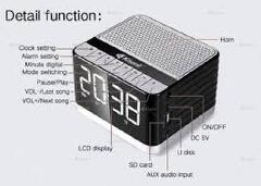 Kisonli G8 Bluetooth Alarm Clock Speaker. It includes an alarm clock, LCD display, hands-free calling via built-in microphone, FM radio, and supports USB, TF/SD card, and AUX inputs.
