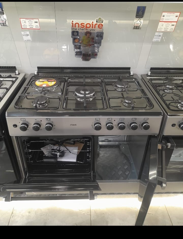 60*90 mika 4 Gas Pool Jet Burners (1 Wok) + 1 RAPID Hot Plate, Auto Ignition, 4 Function Electric Oven, GAS CYLINDER CABINET, Rotisserie, Mirror Black Hob, Silver Body standing cooker