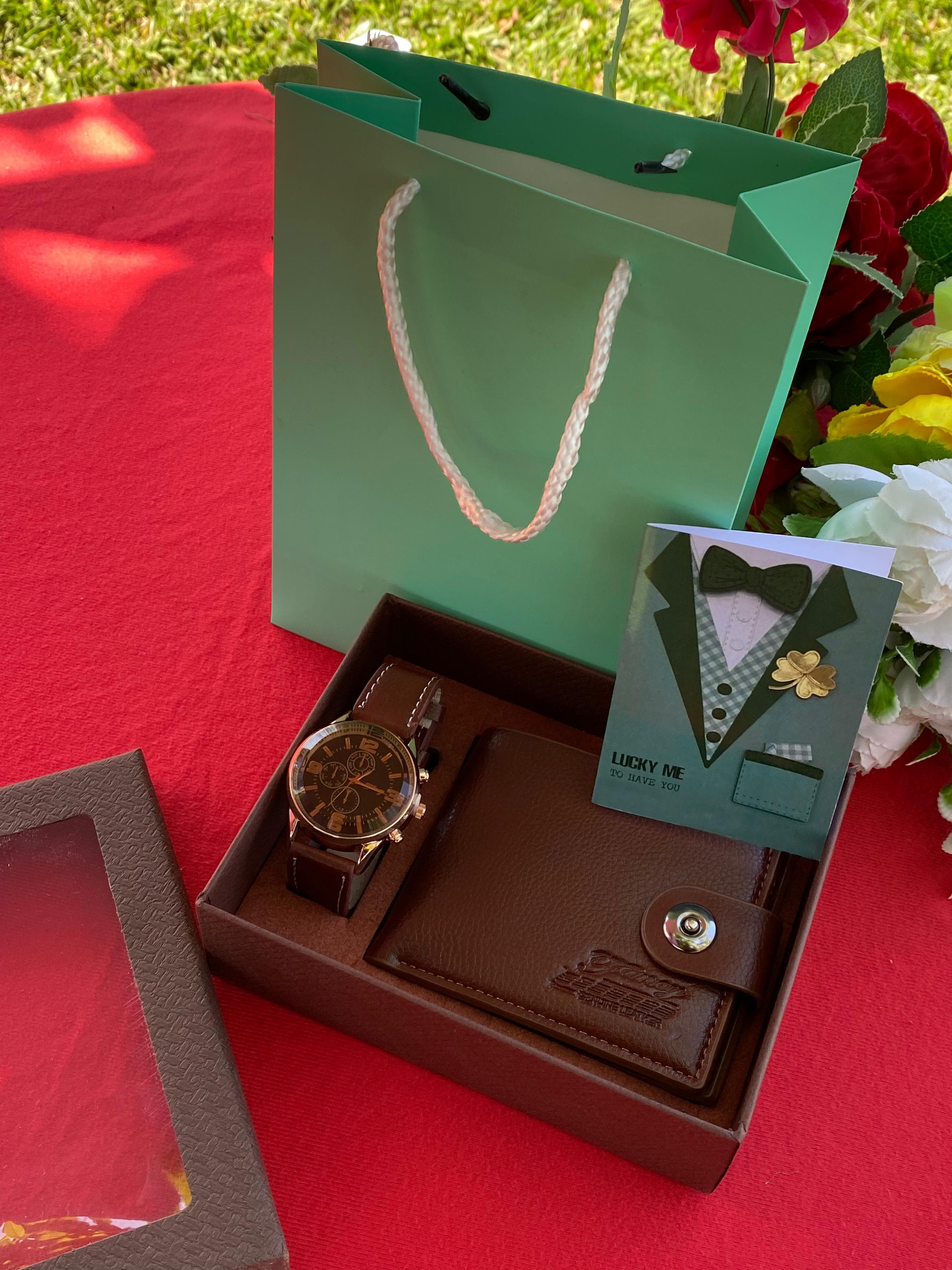 (NEW CLASSY ARRIVAL)Mens modest valentines gift set.Comprises of a watch a card a bag and a wallet.
