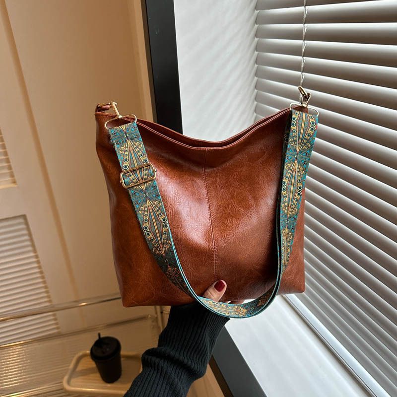 2025 New women's bag,  retro broadband cowhide portable shoulder bag, simple and versatile messenger high-value leather bag