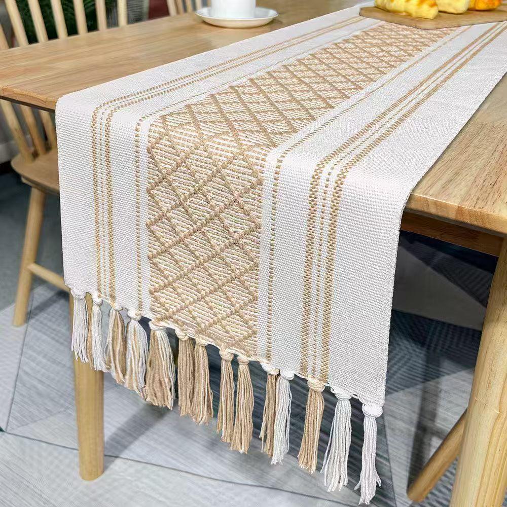 Boho splicing table runner The striking design of our table runner is achieved through meticulous weaving of the geometric pattern and handcrafted knotting of the tassels.