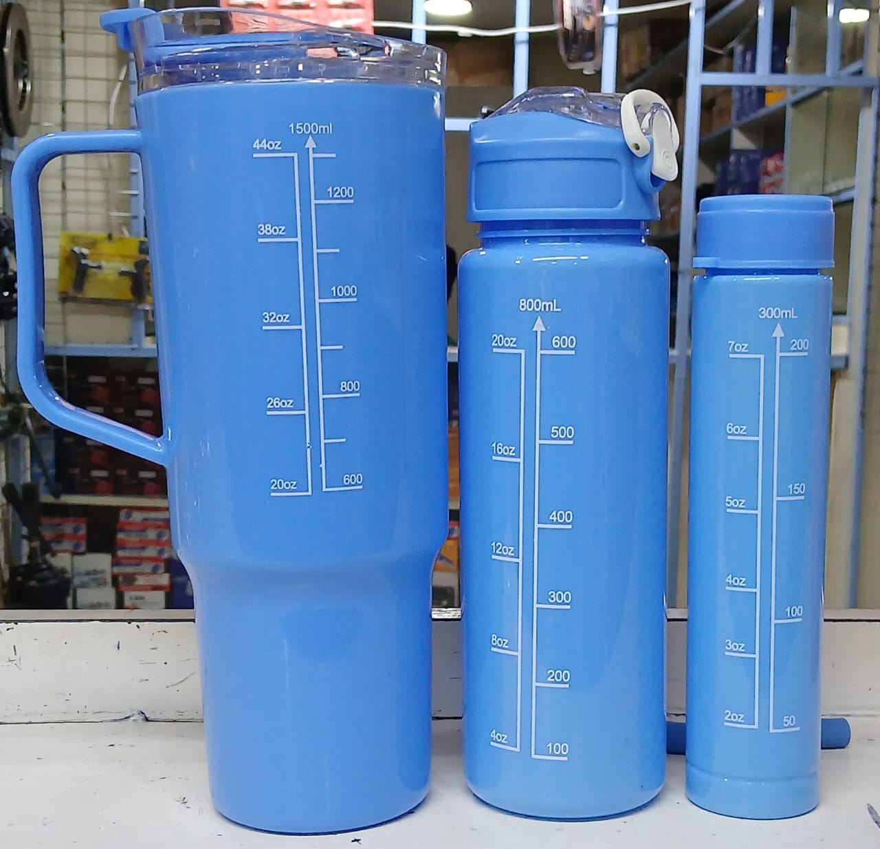 three water bottles. They are a "motivational water bottle set" with time markers to help track daily water intake. 
The set includes three bottles of different sizes: 2000ml, 800ml, and 300ml. 
The b