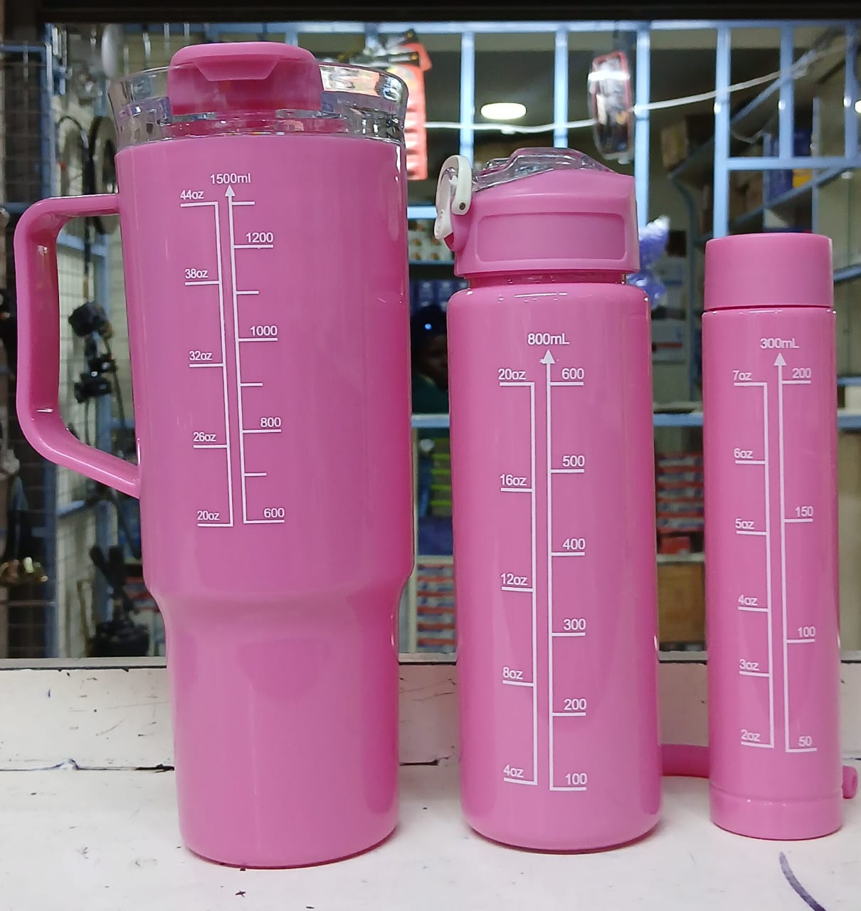 three water bottles. They are a "motivational water bottle set" with time markers to help track daily water intake. 
The set includes three bottles of different sizes: 2000ml, 800ml, and 300ml. 
The b