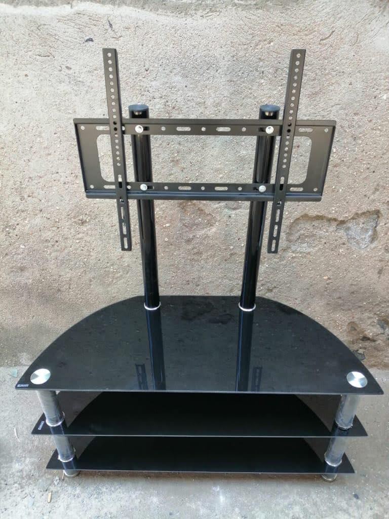 Executive glass tv stand with wall mount.crafted from durable black tempered glass and metal accents, offering a stylish complement to contemporary interiors. It includes a built-in wall mount bracket