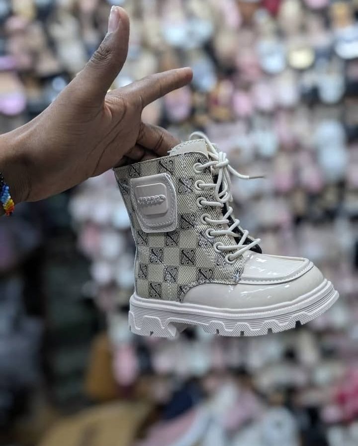 Golden boots girls size 25-30 kids' combat boots with a lace-up front and a stylish side pouch.