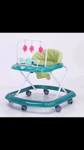 Baby Walker Model 999-1 foldable baby walker with a green seat and interactive toys,foldable design,padded seat, play tray with colorful hanging toys
