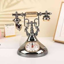 Retro telephone alarm clock decorative table ornaments designed to resemble classic rotary dial telephones.