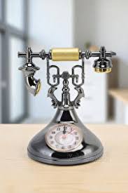 Retro telephone alarm clock decorative table ornaments designed to resemble classic rotary dial telephones.