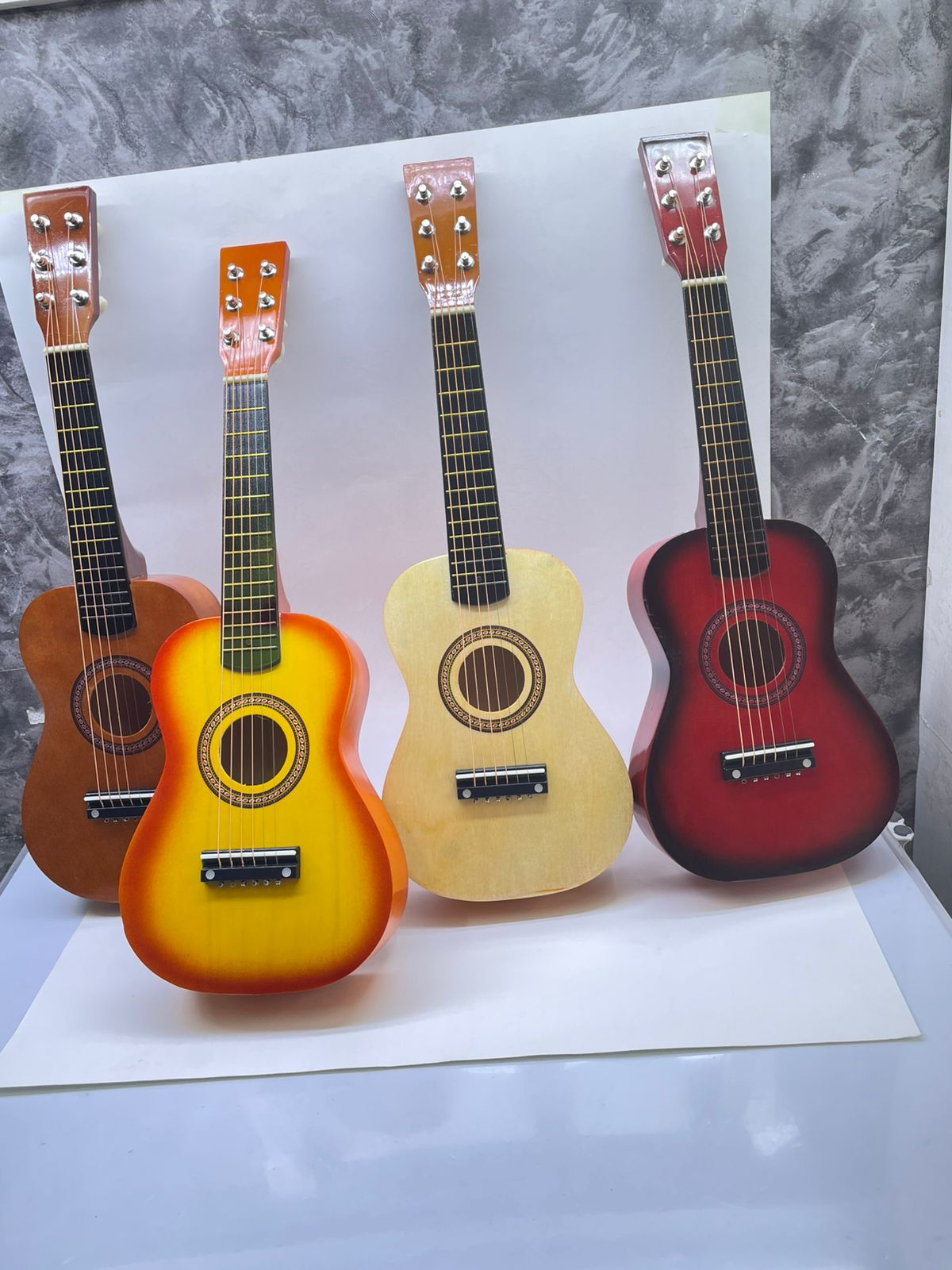 6 strings Acoustic Guitar 23 inches long. Very Crisp and Clear Sound of Strings.has good sound quality & good wooden finishing.It is made up of good quality  & is good for playing and learning.