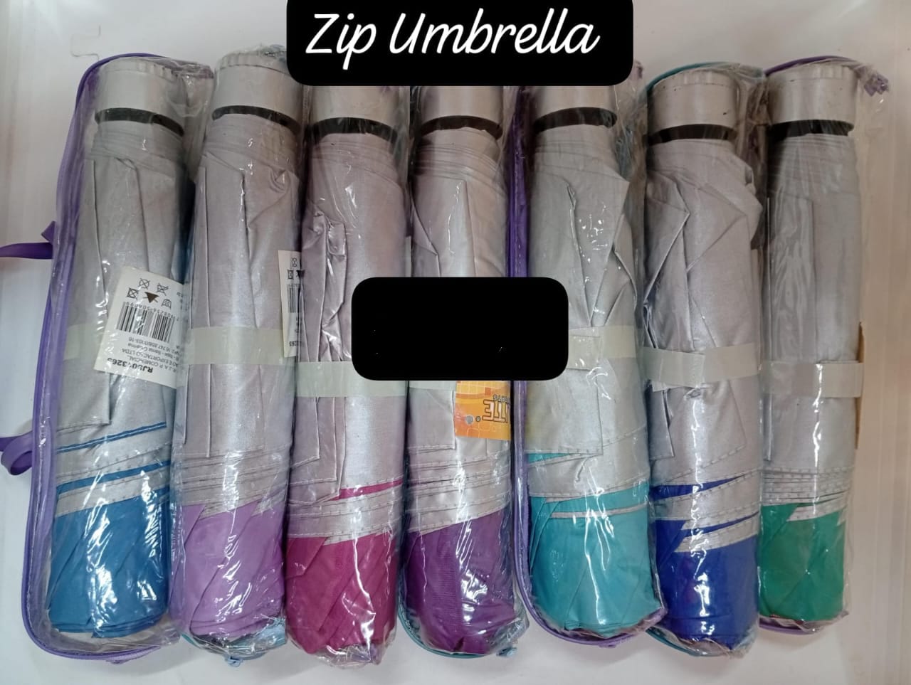 Zip Umbrella" or "Mini Pocket Umbrella."
These are compact, folding umbrellas designed to be easily carried in a bag or pocket. 
They are often made with a water-resistant polyester pongee material.
