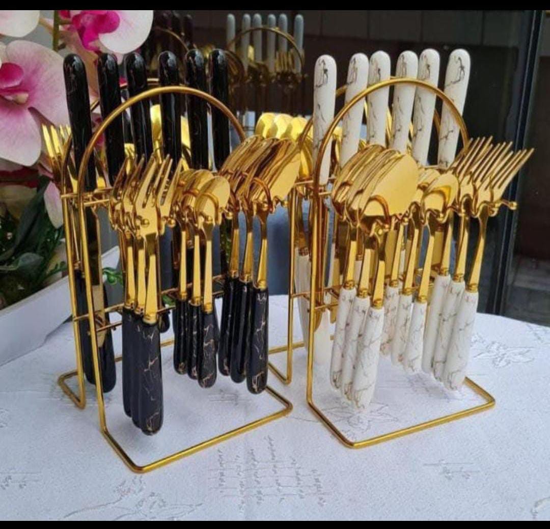 24-piece luxurious marble and gold cutlery set with a stand.
The set includes 6 dinner knives, 6 dinner forks, 6 dinner spoons, and 6 teaspoons. 
It is made of stainless steel with a gold finish and m