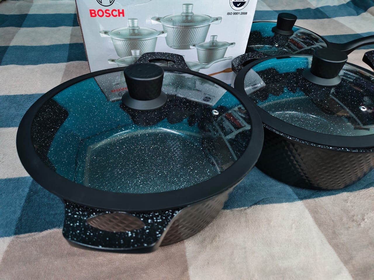 Offer 11 pieces Bosch Granite Non- Stick Quality Cookware Set with An additional Free Mwiko. Contains 4 Cooking sufuria and a pan like sufuria with silicon coated glass lids and removable handles