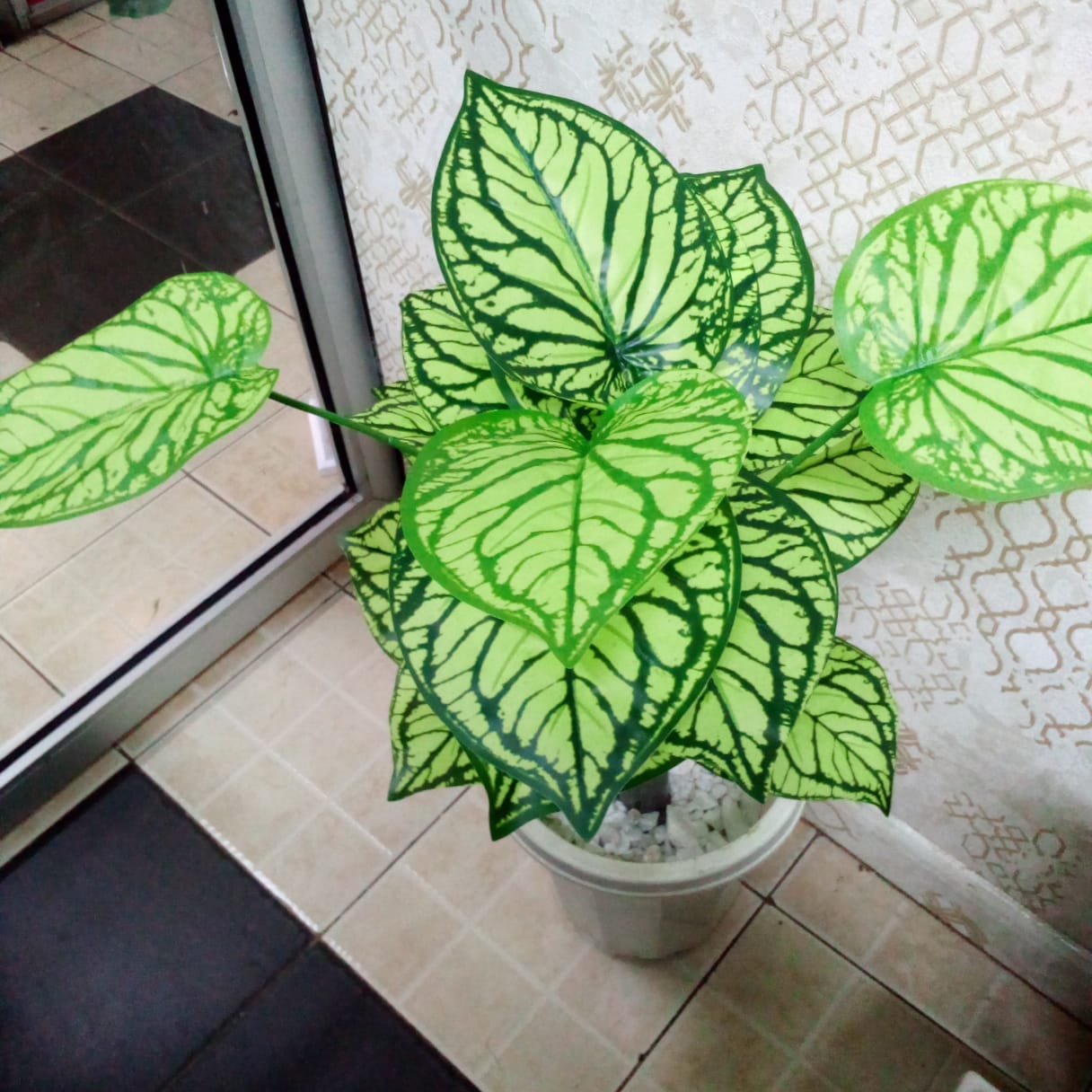 Artificial plant in vase with pebble stones – elegant indoor decor