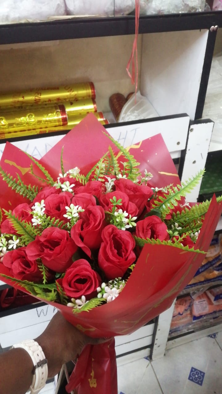 Valentine Teddy bear 40cm long and a bunch of wrapped artificial flowers and in a gift bag