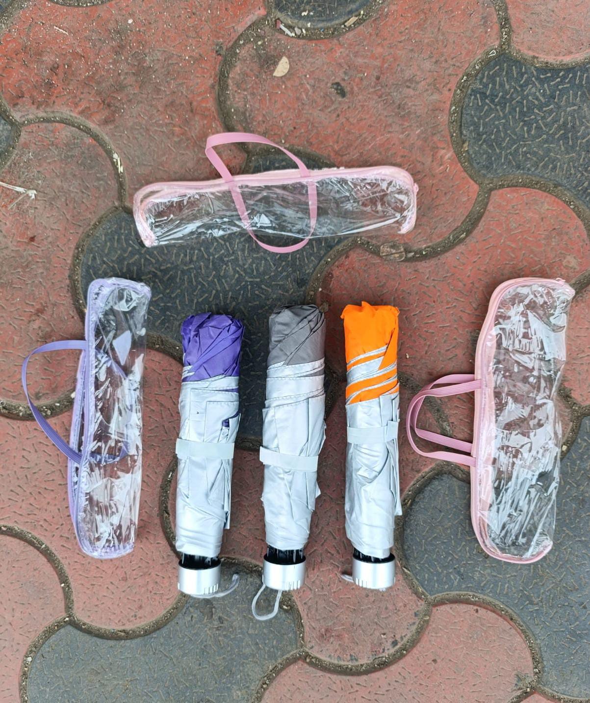 UMBRELLA. High quality wind resistant potable handbag size umbrella, Opens and closes at a press of  button, Compact design so that it can fold into a small piece, Comes with a covering bag.