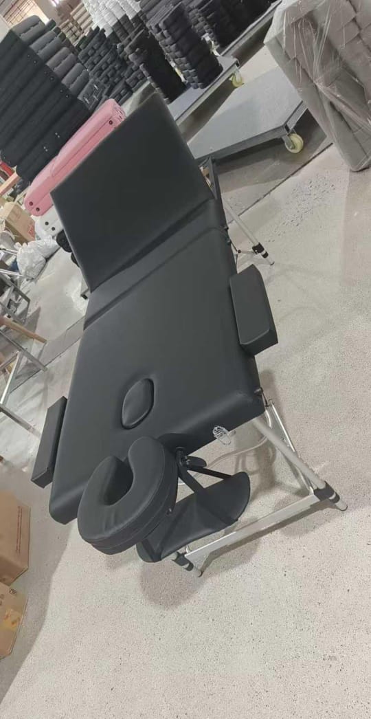 Portable, foldable massage table. It is designed for use by massage therapists, beauticians, or physiotherapists, offering a comfortable surface for clients and easy transport and storage for professi