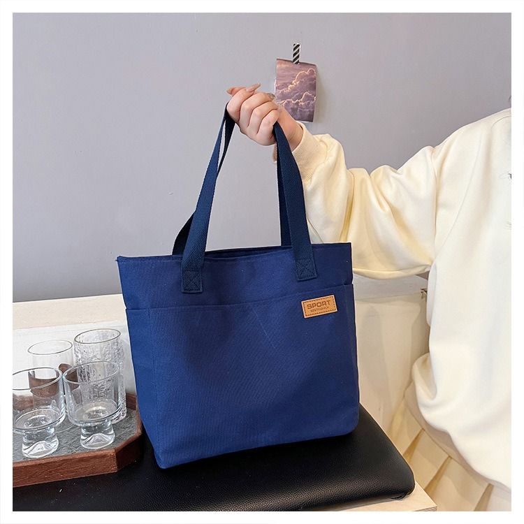 Student Canvas Tote Bag for School Simple Large Capacity Shoulder Bag Versatile Commuting Handbag Literary Style Casual Tote Reusable Handheld Cloth Shopping Bag for Women