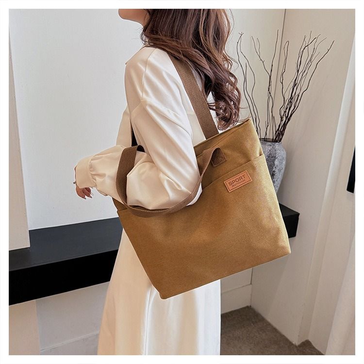 Student Canvas Tote Bag for School Simple Large Capacity Shoulder Bag Versatile Commuting Handbag Literary Style Casual Tote Reusable Handheld Cloth Shopping Bag for Women
