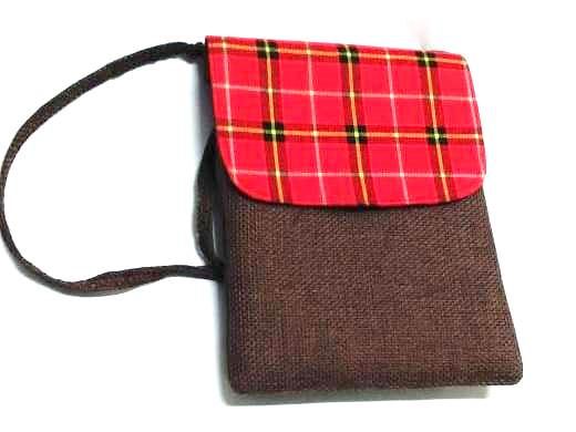 A Maasai shuka print hand-woven sling bag is a vibrant fusion of traditional Maasai textile artistry and contemporary fashion sensibilities.