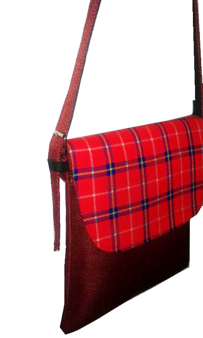 A Maasai shuka print hand-woven sling bag is a vibrant fusion of traditional Maasai textile artistry and contemporary fashion sensibilities.