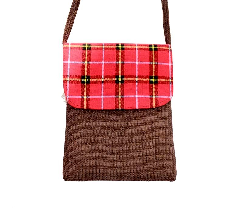 A Maasai shuka print hand-woven sling bag is a vibrant fusion of traditional Maasai textile artistry and contemporary fashion sensibilities.