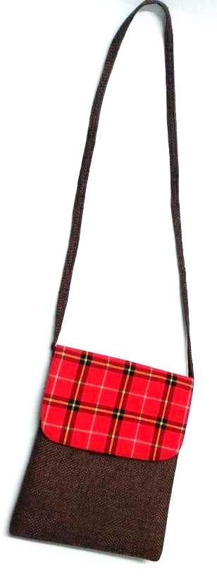 A Maasai shuka print hand-woven sling bag is a vibrant fusion of traditional Maasai textile artistry and contemporary fashion sensibilities.