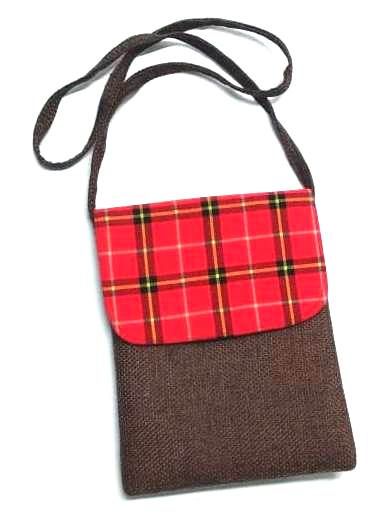 A Maasai shuka print hand-woven sling bag is a vibrant fusion of traditional Maasai textile artistry and contemporary fashion sensibilities.