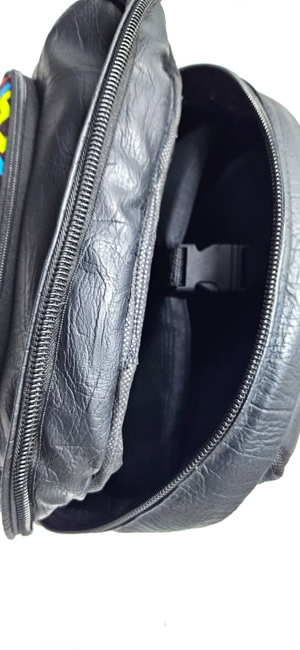 striking black leather backpack, a fusion of modern sophistication and vibrant cultural flair. This unique accessory is designed for the contemporary