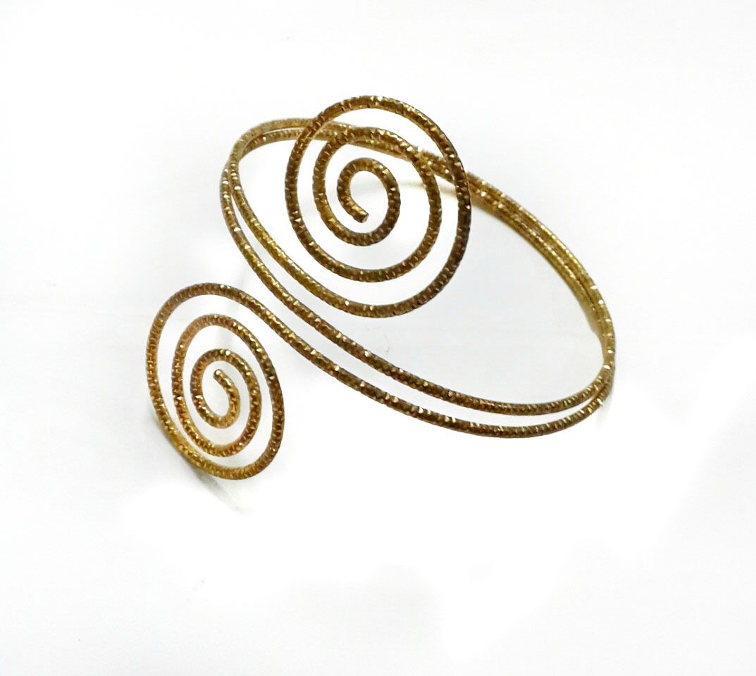 The golden armlet for ladies is a stunning piece of jewelry that effortlessly combines elegance and sophistication