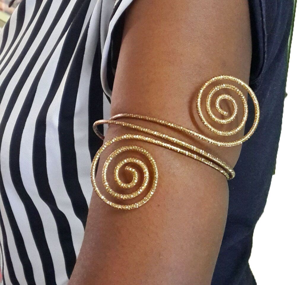 The golden armlet for ladies is a stunning piece of jewelry that effortlessly combines elegance and sophistication